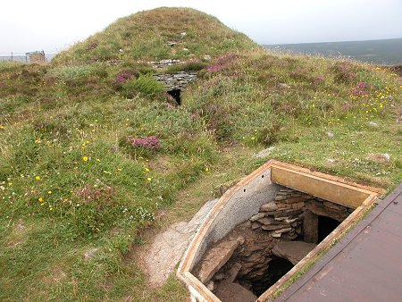 Taversoe Tuick Cairn from the South, with the Miniature Chamber in the Foreground and 
					the Original Entrance to the Lower Chamber in the Background