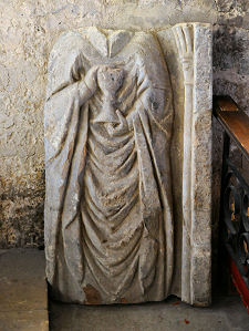 Carving of Priest and Chalice