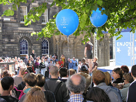 Two Blue Balloons and a Crowd