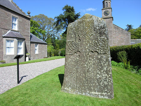 The Front Face of the  Manse Symbol Stone with the Old Manse on the Left and the Church in the Background