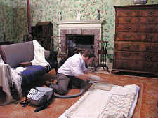 Conservator Cleaning Bedspread