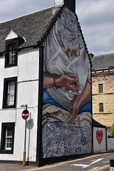 Hand Darner Sitting on a Stool Mural