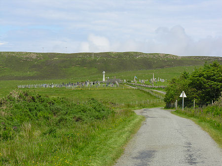 Kilmuir Graveyard Seen from the West. The large standing cross marks Flora MacDonald's grave.