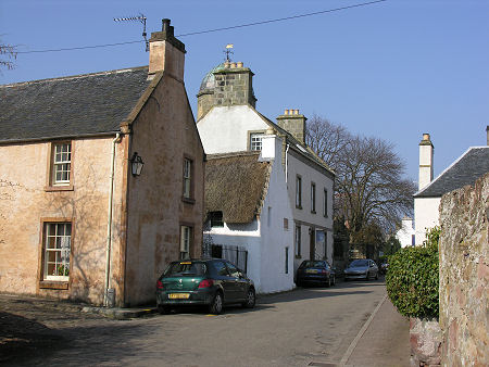 Church Street in Cromarty, with Hugh Miller's Birthplace Cottage (The Thatched Building) with Miller House Beyond
