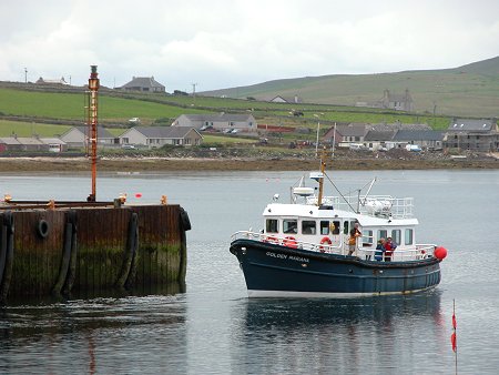 The Papa Westray Ferry Leaves Gill Pier, With Part of Pierowall in the Background
